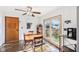 Charming dining area with a wooden table, stylish chairs, and a sliding glass door leading to the yard at 5831 Bar Del W Dr, Indianapolis, IN 46221