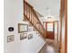 Inviting entryway with wooden staircase and decorative wall art at 5831 Bar Del W Dr, Indianapolis, IN 46221