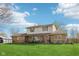 Charming two-story home featuring a covered front porch and a spacious green lawn at 5831 Bar Del W Dr, Indianapolis, IN 46221