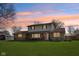 Charming two-story home featuring a covered front porch and a spacious green lawn at 5831 Bar Del W Dr, Indianapolis, IN 46221