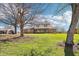 Well-maintained two-story home featuring a large front lawn and mature trees at 5831 Bar Del W Dr, Indianapolis, IN 46221