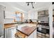 Close-up of a well-equipped kitchen featuring stainless steel appliances and butcher block countertops at 5831 Bar Del W Dr, Indianapolis, IN 46221