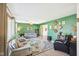 Bright living room with green accent wall, stylish furniture, and ample natural light at 5831 Bar Del W Dr, Indianapolis, IN 46221