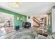 Open-concept living room with a view of the kitchen and staircase at 5831 Bar Del W Dr, Indianapolis, IN 46221