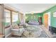 Bright living room with green accent wall, stylish furniture, and ample natural light at 5831 Bar Del W Dr, Indianapolis, IN 46221