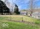 Expansive grassy backyard with mature trees, offering privacy and outdoor space at 5846 Bellsville Pike, Columbus, IN 47201