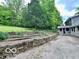 Expansive backyard featuring stone terraces and lush greenery at 5846 Bellsville Pike, Columbus, IN 47201