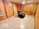 Spacious basement features wood paneling, tile flooring, and a cozy recliner for relaxation at 5846 Bellsville Pike, Columbus, IN 47201