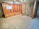 Unfinished basement with wood and stone details, tile flooring, and potential for customization at 5846 Bellsville Pike, Columbus, IN 47201