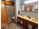 Bathroom featuring double sinks with cabinets and a large mirror at 5846 Bellsville Pike, Columbus, IN 47201