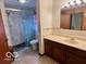 Bathroom with marble shower, matching tile, and double sink vanity at 5846 Bellsville Pike, Columbus, IN 47201