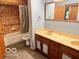 Bathroom featuring double sinks, wood cabinets, and tile flooring at 5846 Bellsville Pike, Columbus, IN 47201