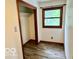 Bedroom featuring neutral walls, wood trim and a window overlooking the outdoor view at 5846 Bellsville Pike, Columbus, IN 47201