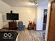 Bedroom with slanted ceilings, wood look floors, tv and closet access at 5846 Bellsville Pike, Columbus, IN 47201