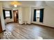 Bright bedroom with wood floors, large windows, and closet access at 5846 Bellsville Pike, Columbus, IN 47201