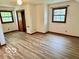 Well-lit bedroom featuring neutral paint, modern floors, and two large windows at 5846 Bellsville Pike, Columbus, IN 47201