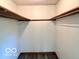 View of the empty walk-in closet with wood trim and modern floors at 5846 Bellsville Pike, Columbus, IN 47201