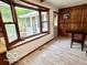 Bright dining area with a bay window and wood paneling at 5846 Bellsville Pike, Columbus, IN 47201
