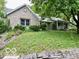 Beautiful stone exterior of a well-maintained home with mature trees and landscaping at 5846 Bellsville Pike, Columbus, IN 47201