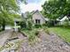 Well-maintained home with a landscaped front yard, stone accents, and a detached garage at 5846 Bellsville Pike, Columbus, IN 47201
