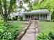Charming home featuring stone accents, a covered front porch, and a lush front yard at 5846 Bellsville Pike, Columbus, IN 47201