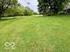 Expansive lawn with mature trees, offering ample space and scenic views at 5846 Bellsville Pike, Columbus, IN 47201