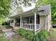 Inviting front porch with a cozy bench and classic white railing at 5846 Bellsville Pike, Columbus, IN 47201