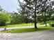 Expansive front yard featuring mature trees and a well-maintained lawn at 5846 Bellsville Pike, Columbus, IN 47201