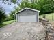 View of the detached garage with gray siding and white garage door at 5846 Bellsville Pike, Columbus, IN 47201