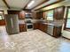 Well-lit kitchen featuring stainless steel appliances, dark wood cabinetry, and tile backsplash at 5846 Bellsville Pike, Columbus, IN 47201