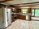 Bright kitchen with stainless steel appliances, wooden cabinets, and a large window view at 5846 Bellsville Pike, Columbus, IN 47201