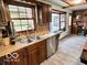 Traditional kitchen with wood cabinets, a stainless steel dishwasher, and a double sink at 5846 Bellsville Pike, Columbus, IN 47201