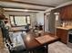 Cozy kitchen featuring wood cabinets, stainless steel appliances, and an eat-in dining area at 5846 Bellsville Pike, Columbus, IN 47201