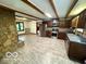 Open concept kitchen featuring stainless steel appliances, wood cabinets, and a stone accent wall at 5846 Bellsville Pike, Columbus, IN 47201
