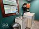 Functional laundry room with a utility sink, washer, and ample storage space at 5846 Bellsville Pike, Columbus, IN 47201