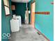 Functional laundry room with utility sink, washer and dryer hookups, and durable flooring at 5846 Bellsville Pike, Columbus, IN 47201
