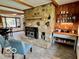 Inviting living room with a stone fireplace, wood beams, and open floor plan at 5846 Bellsville Pike, Columbus, IN 47201