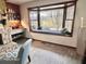 Cozy seating next to a window seat in a living room that features a beautiful stone fireplace at 5846 Bellsville Pike, Columbus, IN 47201