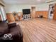 Well-lit living room with wood paneling, comfortable seating, and entertainment center at 5846 Bellsville Pike, Columbus, IN 47201