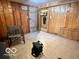 Spacious room with tile floors, wood paneling, and an accessible closet for storage at 5846 Bellsville Pike, Columbus, IN 47201