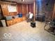 Functional room with tile floor, wood paneling, and storage shelves for organization at 5846 Bellsville Pike, Columbus, IN 47201