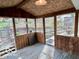 Relaxing screened-in porch with wooden floors and a view of the backyard and greenery at 5846 Bellsville Pike, Columbus, IN 47201