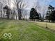 Large, well-maintained front yard with mature trees, enhancing the property's curb appeal at 5846 Bellsville Pike, Columbus, IN 47201