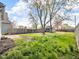 Spacious backyard with lush grass, mature trees, and a detached garage at 609 E Southern Ave, Indianapolis, IN 46203