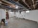 Unfinished basement featuring painted walls, exposed utilities, and concrete floors at 609 E Southern Ave, Indianapolis, IN 46203
