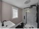Bathroom featuring sleek, modern design with tiled shower and stylish vanity at 609 E Southern Ave, Indianapolis, IN 46203