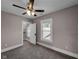 Comfortable bedroom featuring a ceiling fan, closet, and large window for natural light at 609 E Southern Ave, Indianapolis, IN 46203