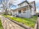 Charming home with a classic front porch, complemented by a green lawn and mature trees at 609 E Southern Ave, Indianapolis, IN 46203