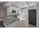 Modern kitchen with stainless steel appliances, granite countertops, and bright lighting at 609 E Southern Ave, Indianapolis, IN 46203
