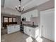 Well-lit kitchen features white cabinets, stainless appliances, and granite countertops at 609 E Southern Ave, Indianapolis, IN 46203